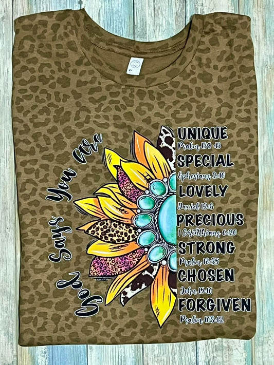 A brown leopard print t-shirt with a colorful sunflower design and text that includes phrases such as 'unique', 'special', and 'chosen'.