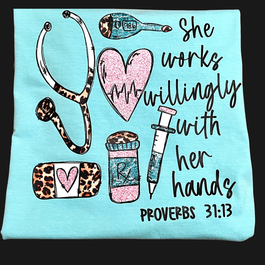 Light mint color shirt with medical-themed graphics and text saying she works willingly with her hands, Proverbs 31:13 on a black background   available in short or long sleeve tee