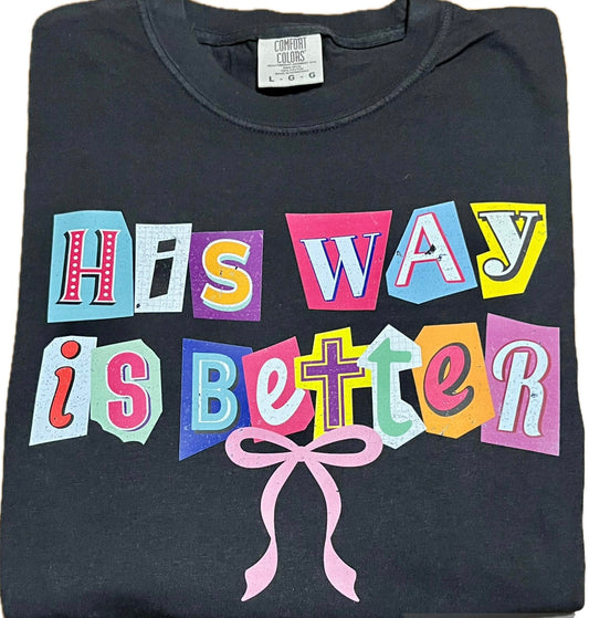 Black t-shirt with colorful text 'His Way is Better' and a pink bow on a white background