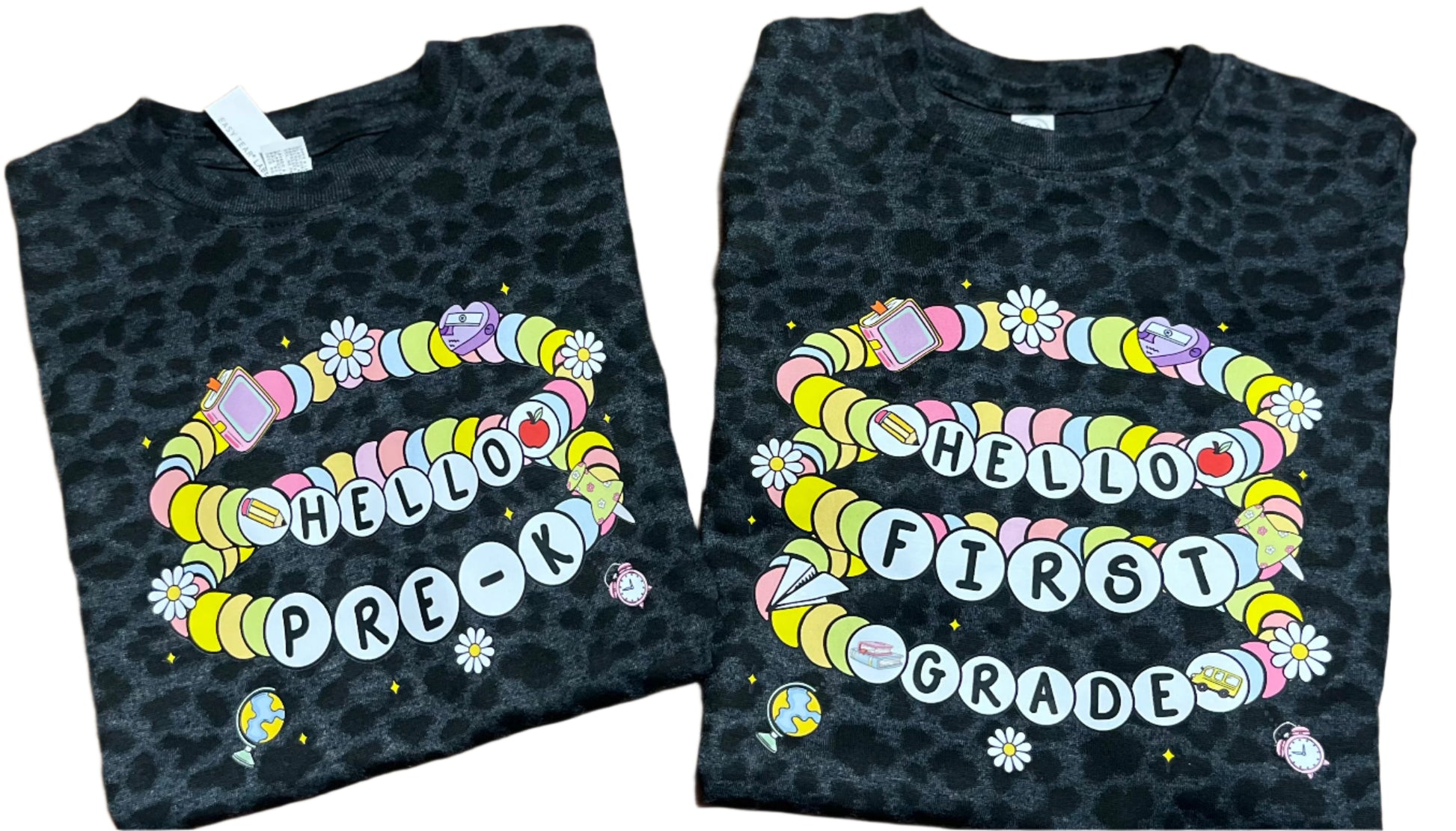 two black leopard tshirt with friendship bracelets saying hello pre-k and hello first grade on white background