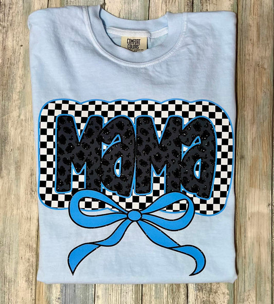 A folded light blue shirt with a black mama leopard design and a blue coquette bow graphic on the front.