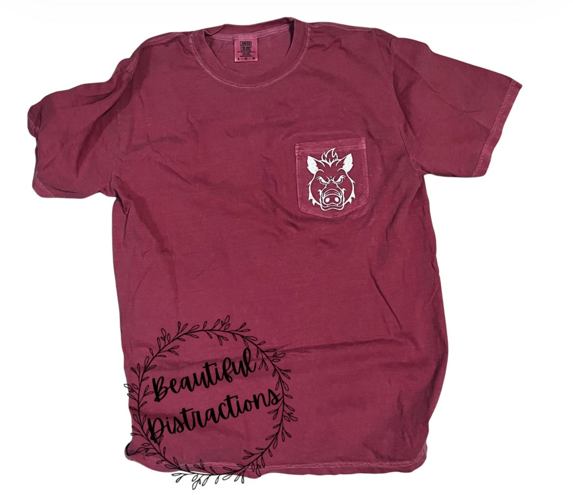 Maroon t-shirt with an embroidered hog pocket design in white thread and 'Beautiful Distractions' branding on a white background