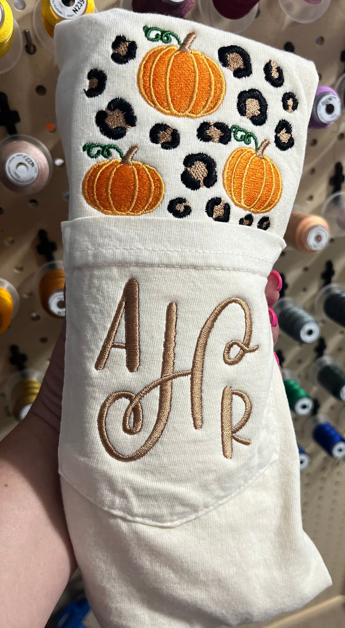 Comfort colors short sleeve pocket tee in the color ivory with 
Embroidered pumpkins and leopard spots above the pocket with  monogram, AHR, embroidered on the pocket area lying on woven surface

Pocket will be sewn shut

Personalization available - Hello pumpkin will be sewn on the pocket unless monogram is requested.
 If adding monogram list name or initials in personalization box in order of first name, last name, middle name