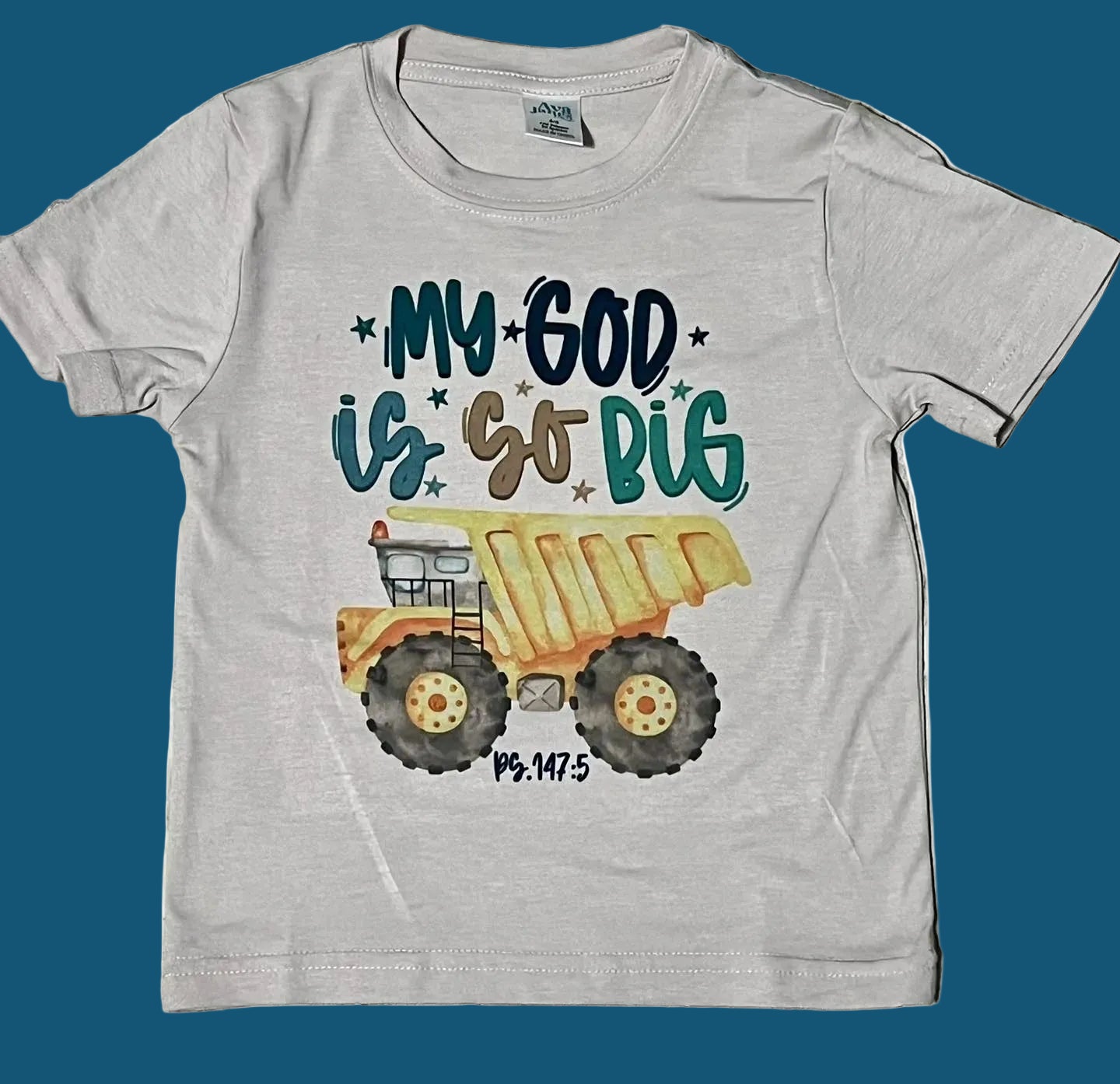 A gray t-shirt with a graphic print of a dump truck and the phrase 'My God is so big'