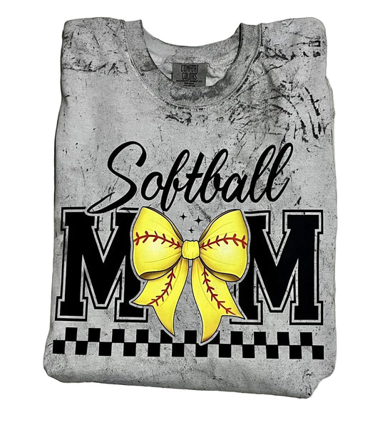 A gray t-shirt with the words 'Softball MOM' on it, featuring a yellow bow design and softball stitching details.