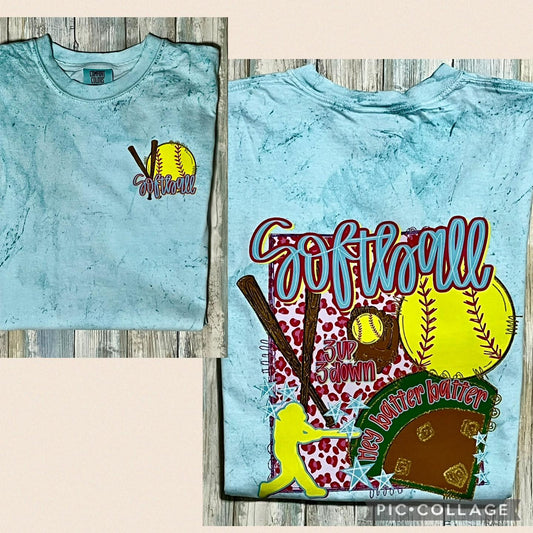 A t-shirt with a softball theme, featuring text and graphics related to the sport on both the front and back, in a seaglass blue color.