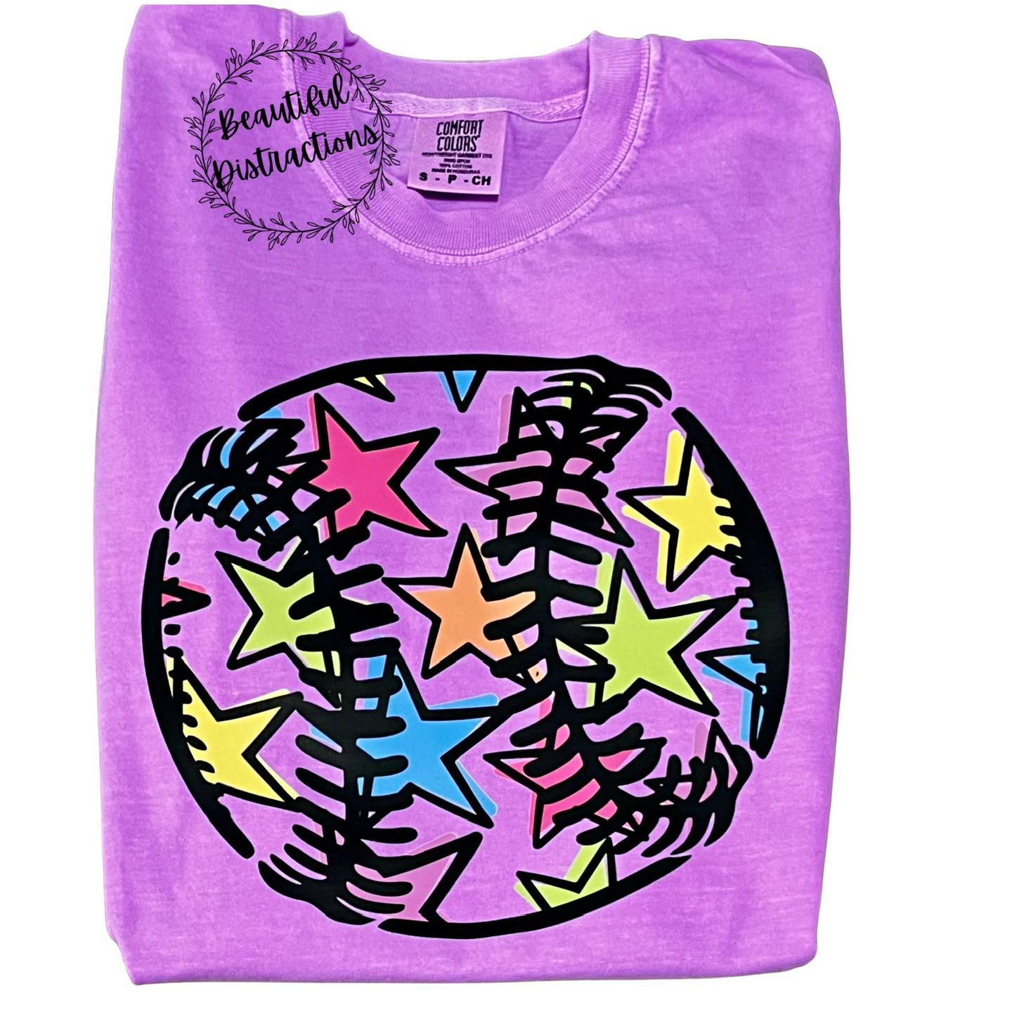 neon  violet short sleeve tee with a decal of a baseball outline filled with random color stars